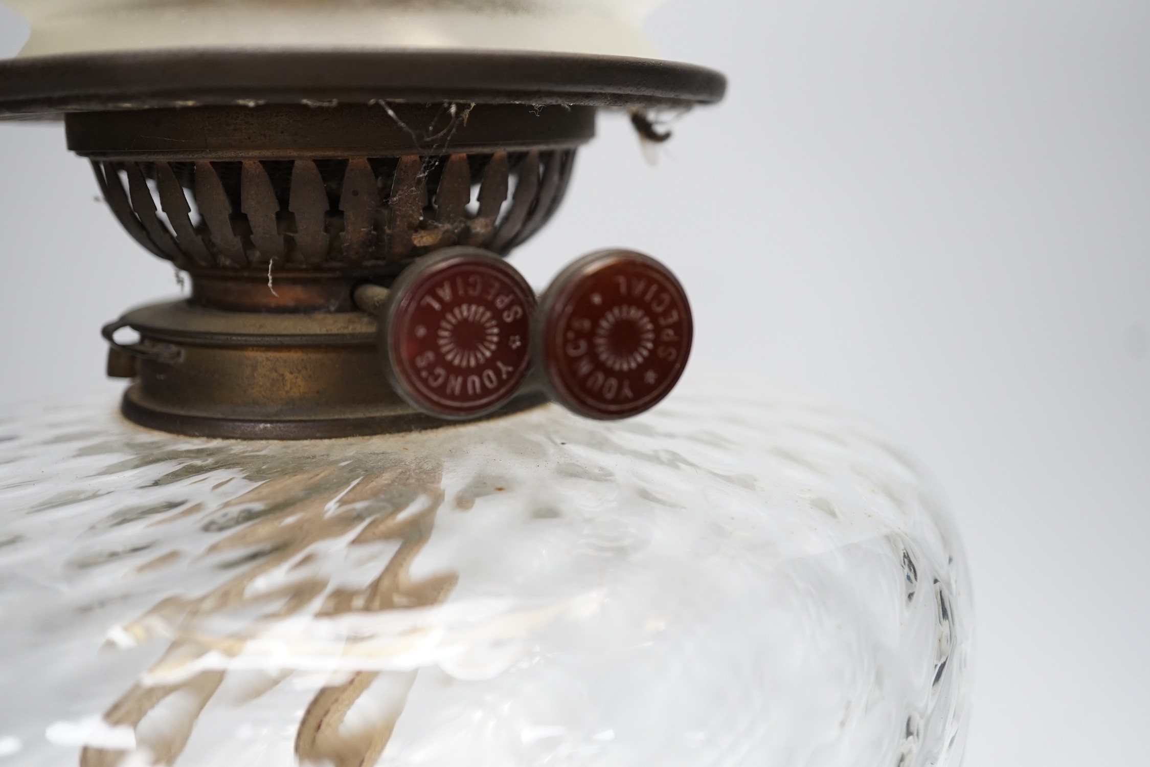 A Victorian brass stemmed oil lamp and glass shade, 50cms including shade